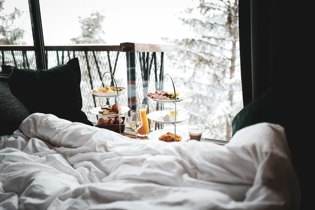 How Digital Loyalty Schemes Are Rewriting Guest Retention Economics 4 Breakfast in bed with mountain view through large window in cozy hotel room