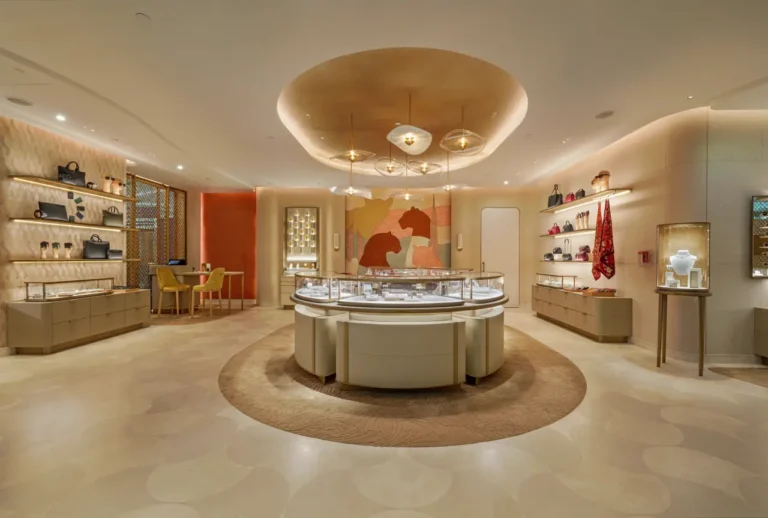 Interior view of Cartier boutique at Dubai International Airport featuring jewelry displays, luxury handbags, and design elements inspired by Dubai’s skyline.