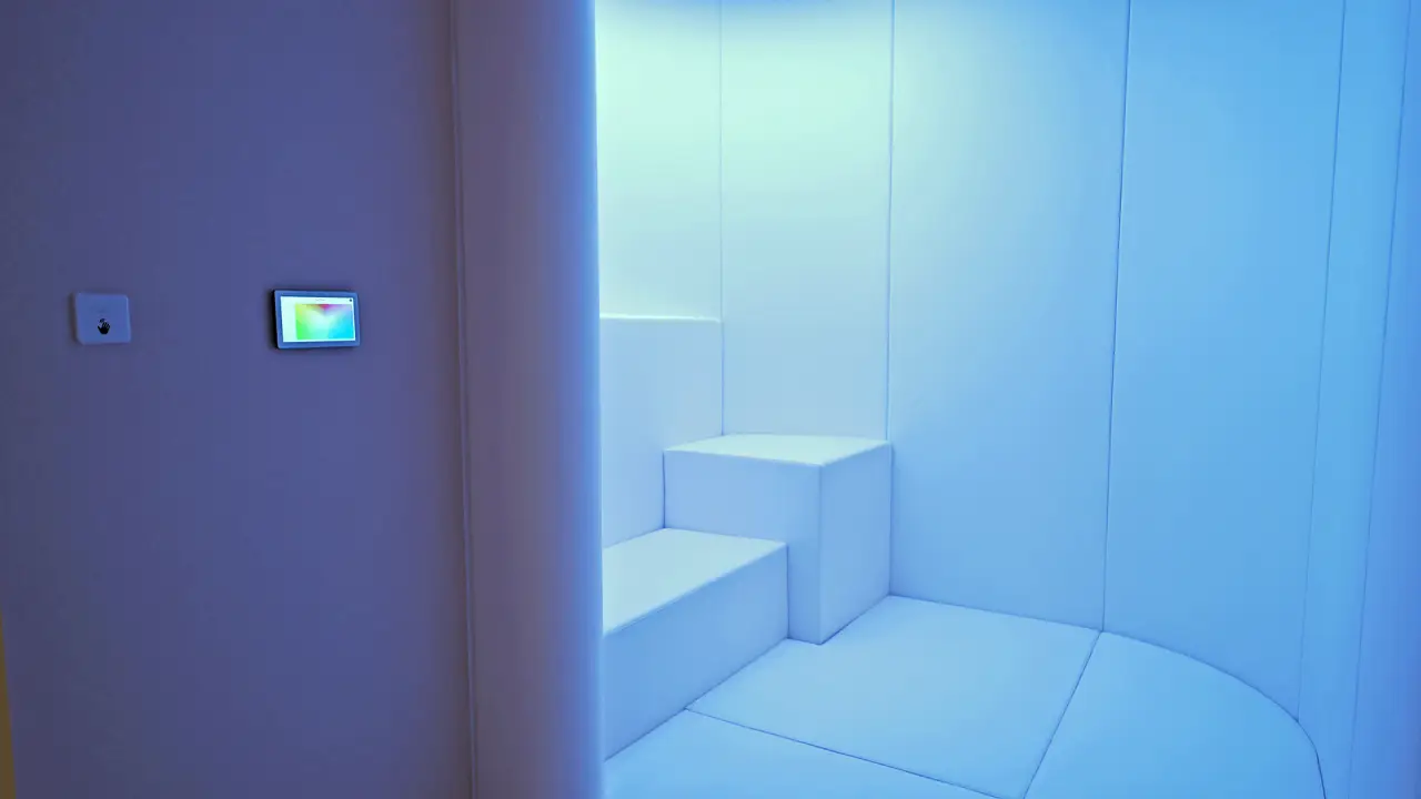 Changi Airport’s Calm Room Welcomes Travellers With Invisible Disabilities 5 Soundproof blue-lit sensory room with cushioned seating inside The Nest at Changi Airport’s Calm Room