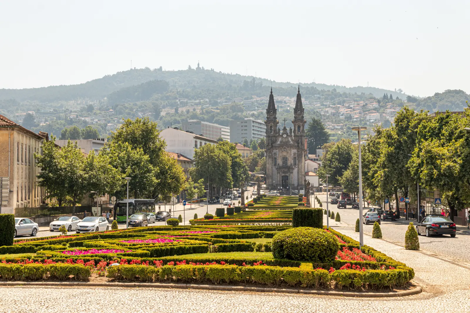 Best Places To Travel In 2026—National Geographic’s Top Picks 3 View of the historic city of Guimarães, Portugal, with colorful gardens and the Church of Nossa Senhora da Consolação in the background.