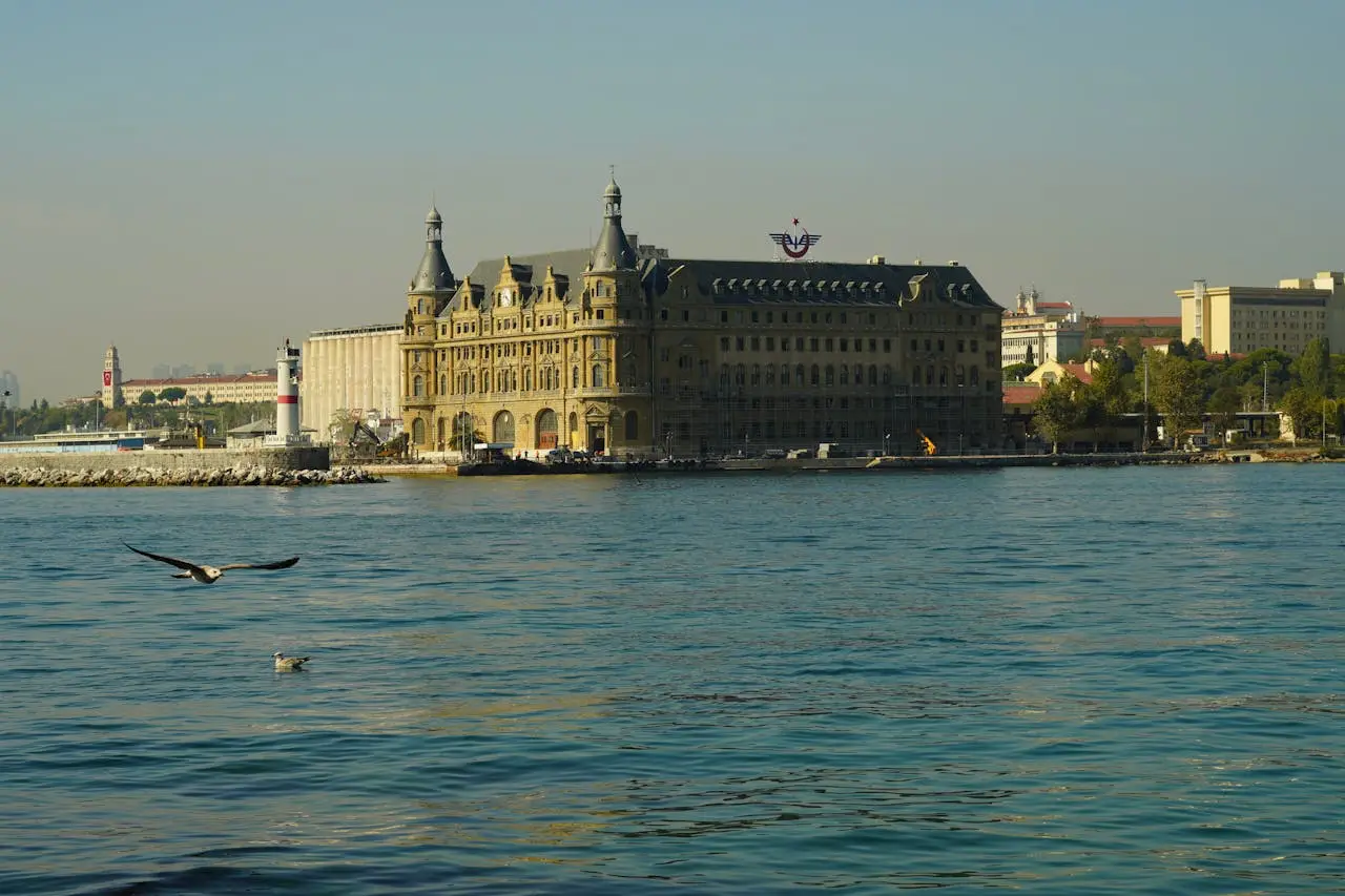 How To Plan A Bosphorus Yacht Cruise In Istanbul 2 Historic waterfront railway station building with seagulls flying over the Bosphorus in Istanbul.