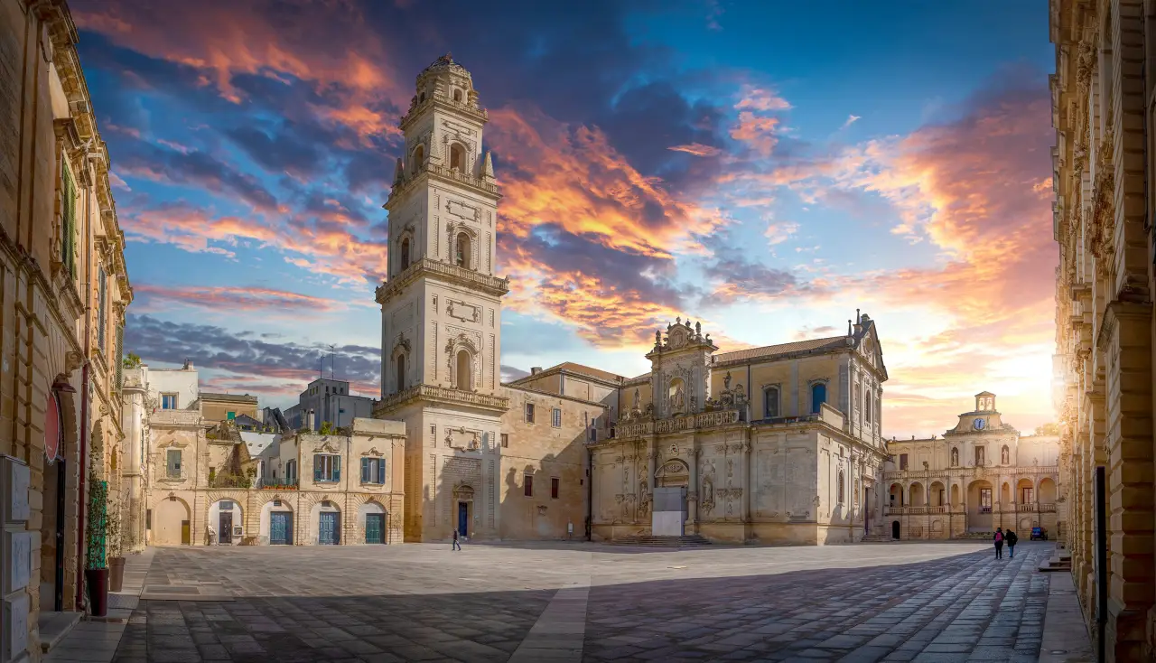 Sunset over Lecce Cathedral and Bell Tower in the historic centre of Lecce, Italy.