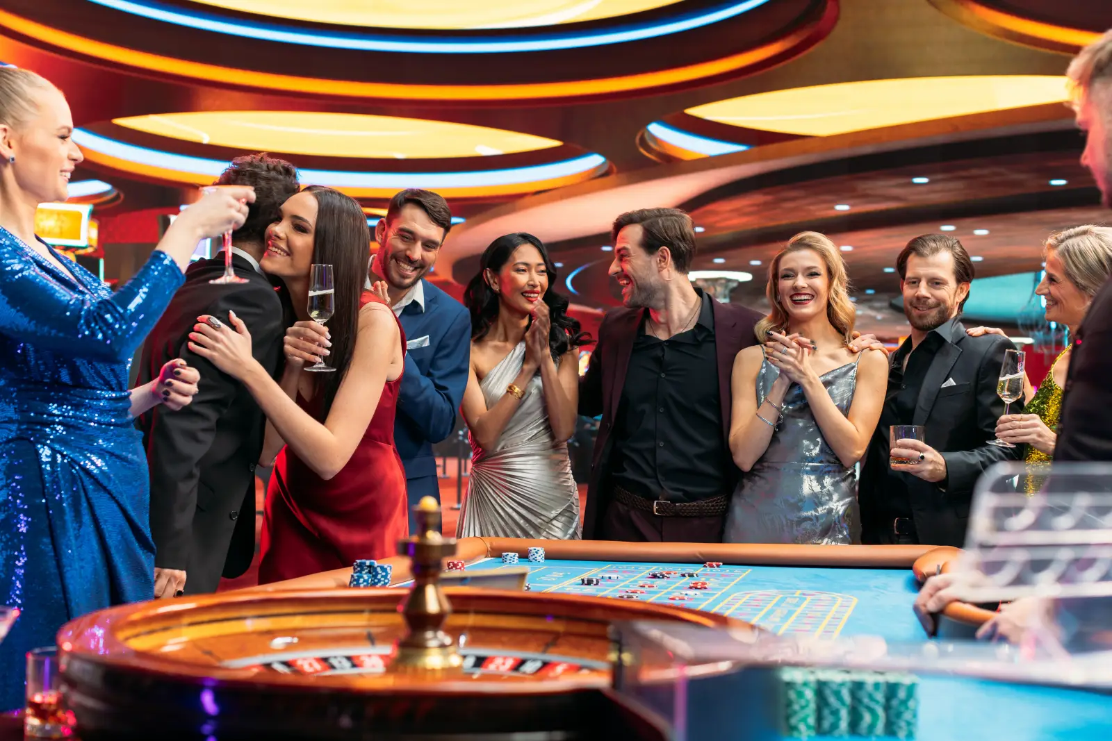 The Evolution Of Elegance: How Casinos Became Symbols Of Luxury 2 Elegant group of friends celebrating around a roulette table in a luxurious casino.