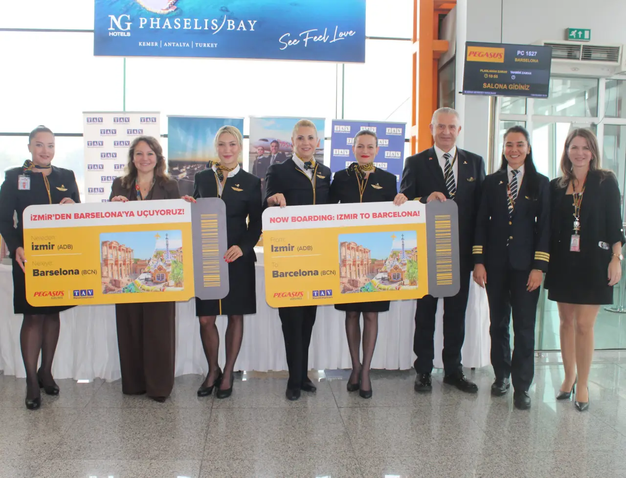 Pegasus Airlines Launches Low-Cost Flights Between Izmir and Barcelona 46 Pegasus Airlines cabin crew and staff holding large boarding pass signs for the new Izmir to Barcelona flight launch.
