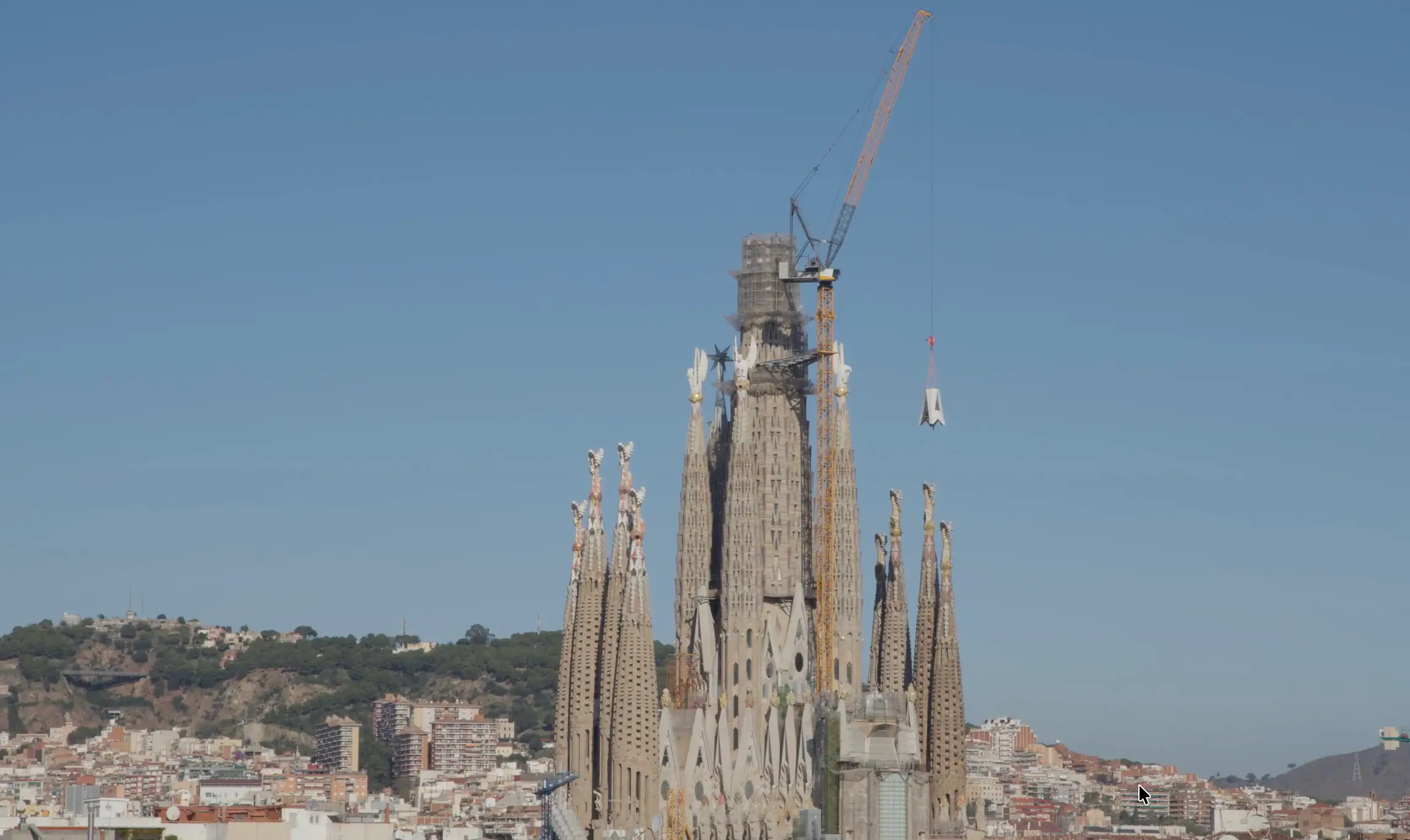 Sagrada Família Installs First Element of Tower of Jesus Cross 6 A crane lifts the first element of the Tower of Jesus cross above the Sagrada Família in Barcelona.