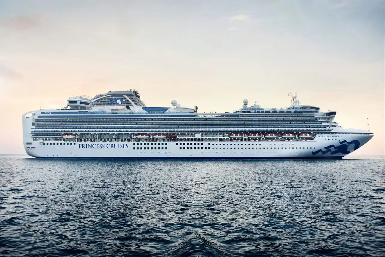 A full exterior side-view of the cruise ship Sapphire Princess from Princess Cruises sailing on the sea.
