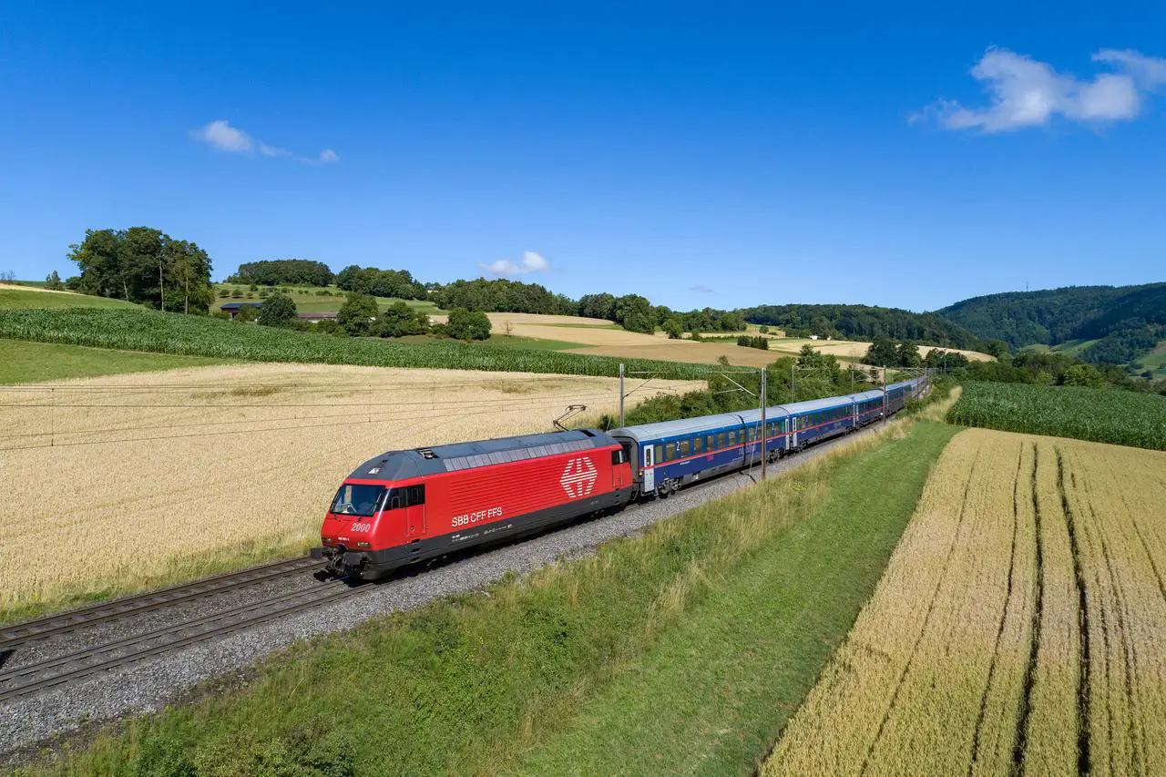 SBB EuroNight train travels through the Swiss countryside on a sunny day