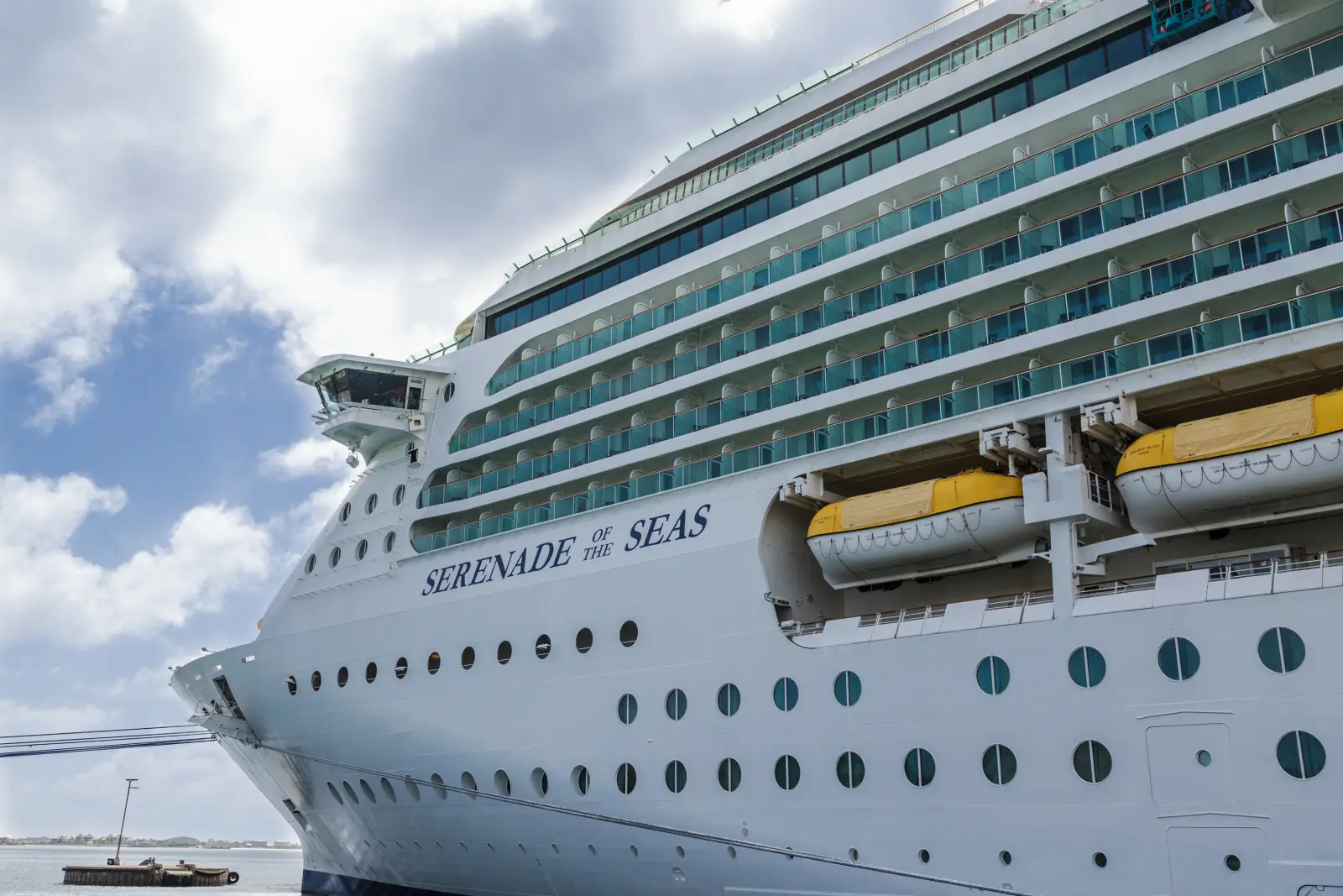 Cruise ship Serenade of the Seas docked at port with lifeboats visible.