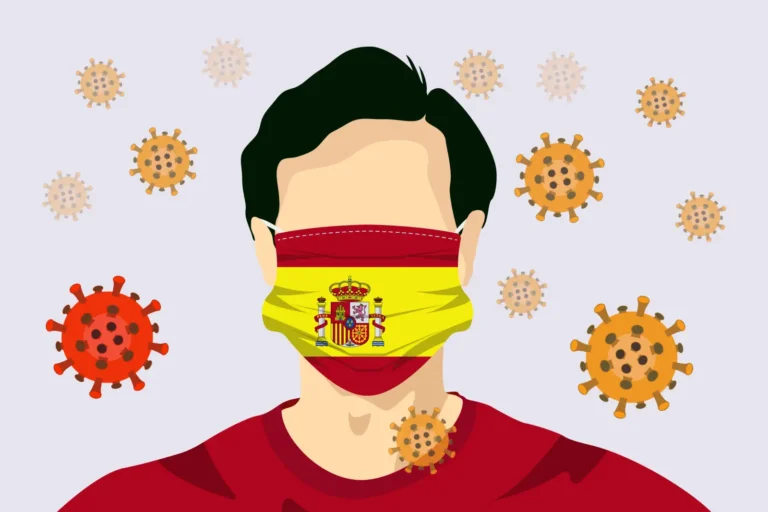 Illustration of a person wearing a face mask with Spain’s flag surrounded by coronavirus particles.