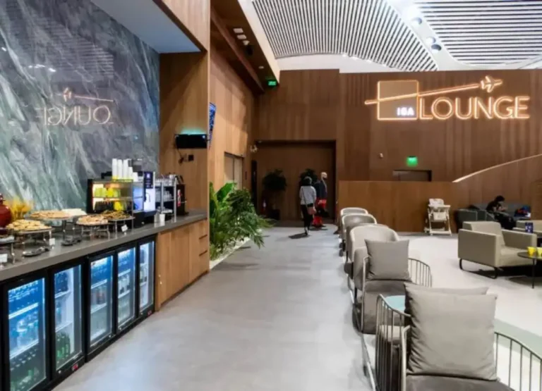 Interior view of the İGA Lounge at Istanbul Airport, featuring seating areas and a self-service food counter.