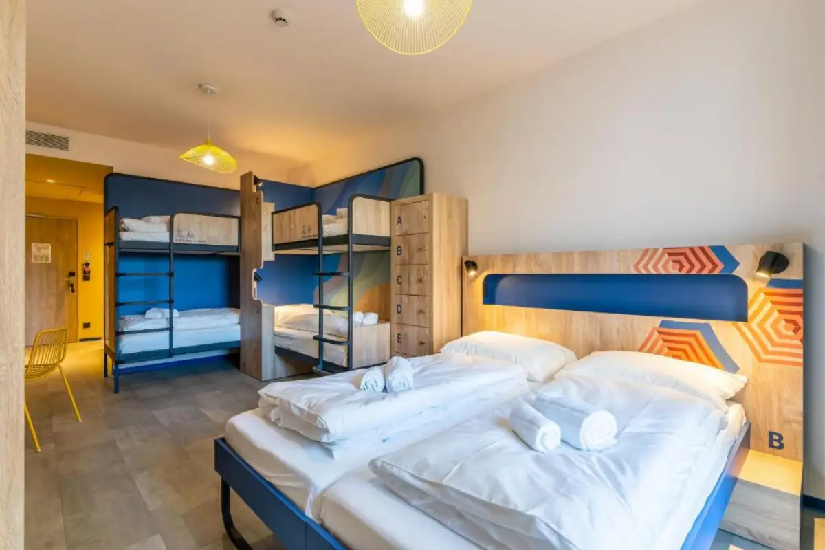 Modern hybrid hostel room with bunk beds and a double bed at MEININGER Marseille Centre la Joliette.