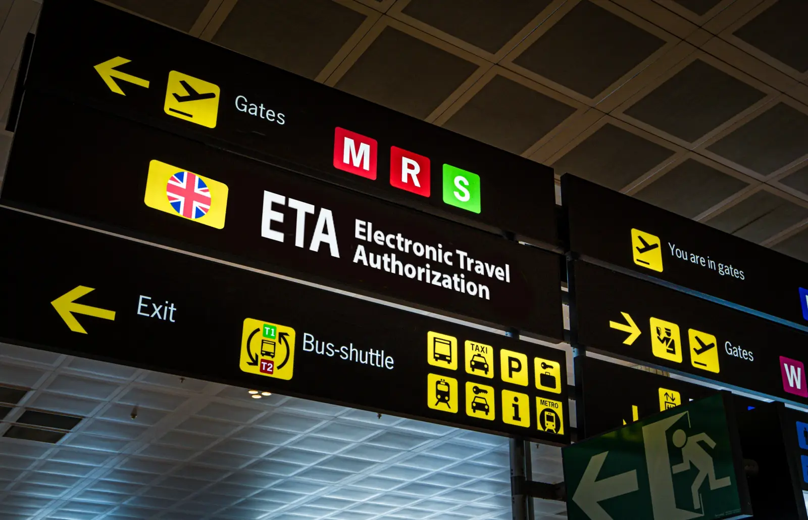 Uk To Require Travel Permission From 85 Countries 2 Airport signage showing directions for ETA Electronic Travel Authorization and passenger services.