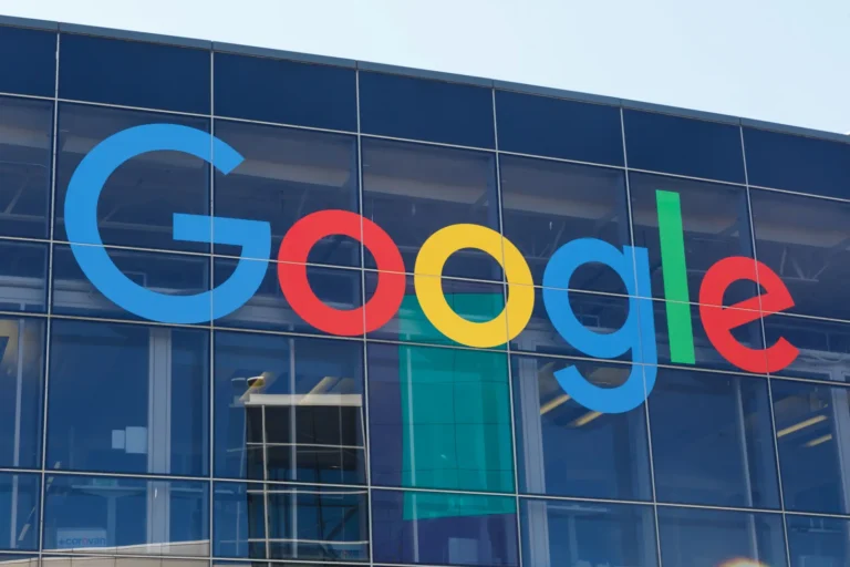 Technology 9 Google logo displayed on the exterior glass wall of a modern office building.