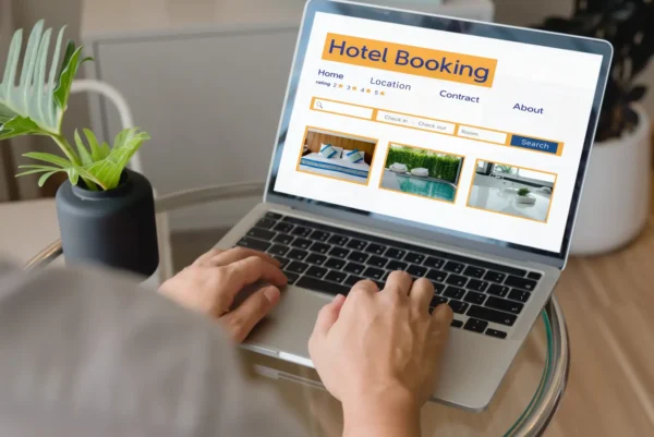 Person using a laptop to search for hotels on an online booking website.