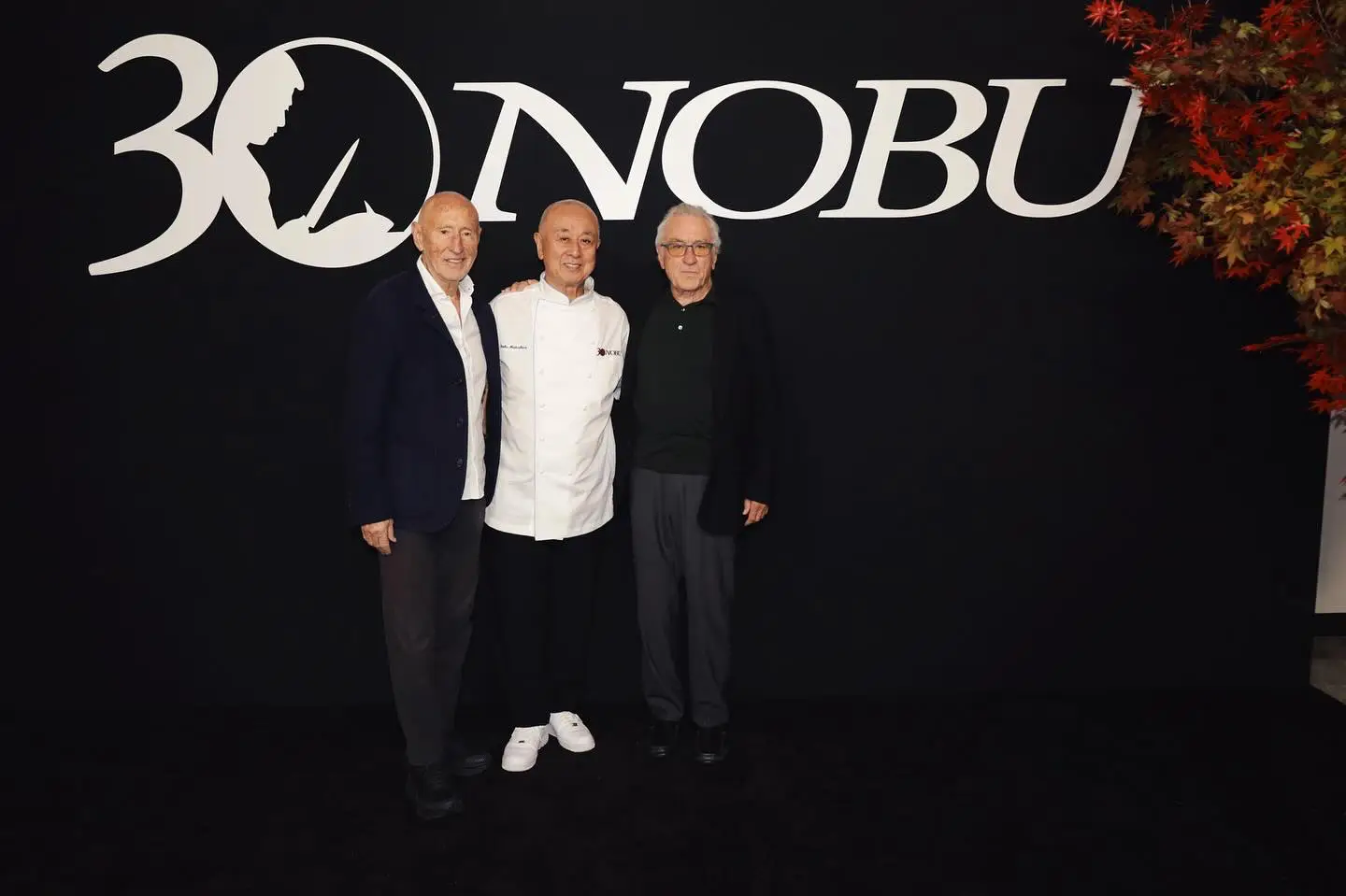 Three co-founders of Nobu Hospitality posing together at the brand’s 30th anniversary event.