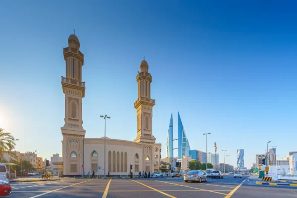 Panoramic daytime view of Ras Rumman Mosque with Bahrain World Trade Center in the background in Manama.