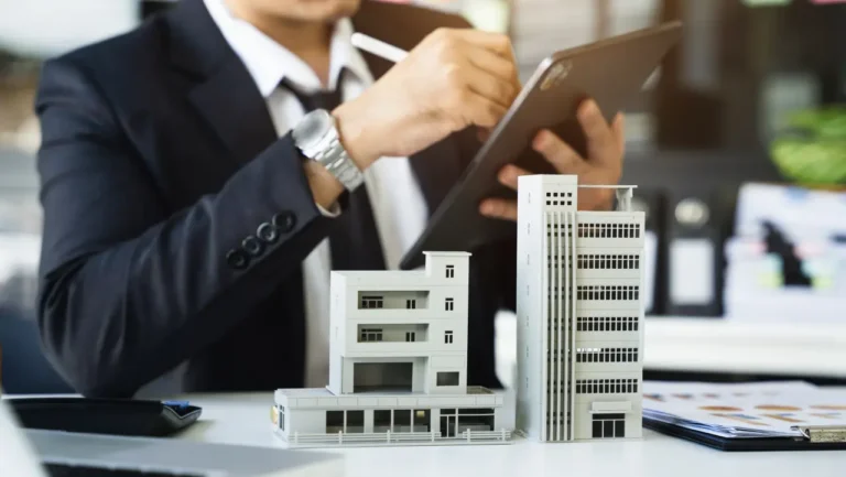 Other News 21 Business professional reviewing real estate documents with building models