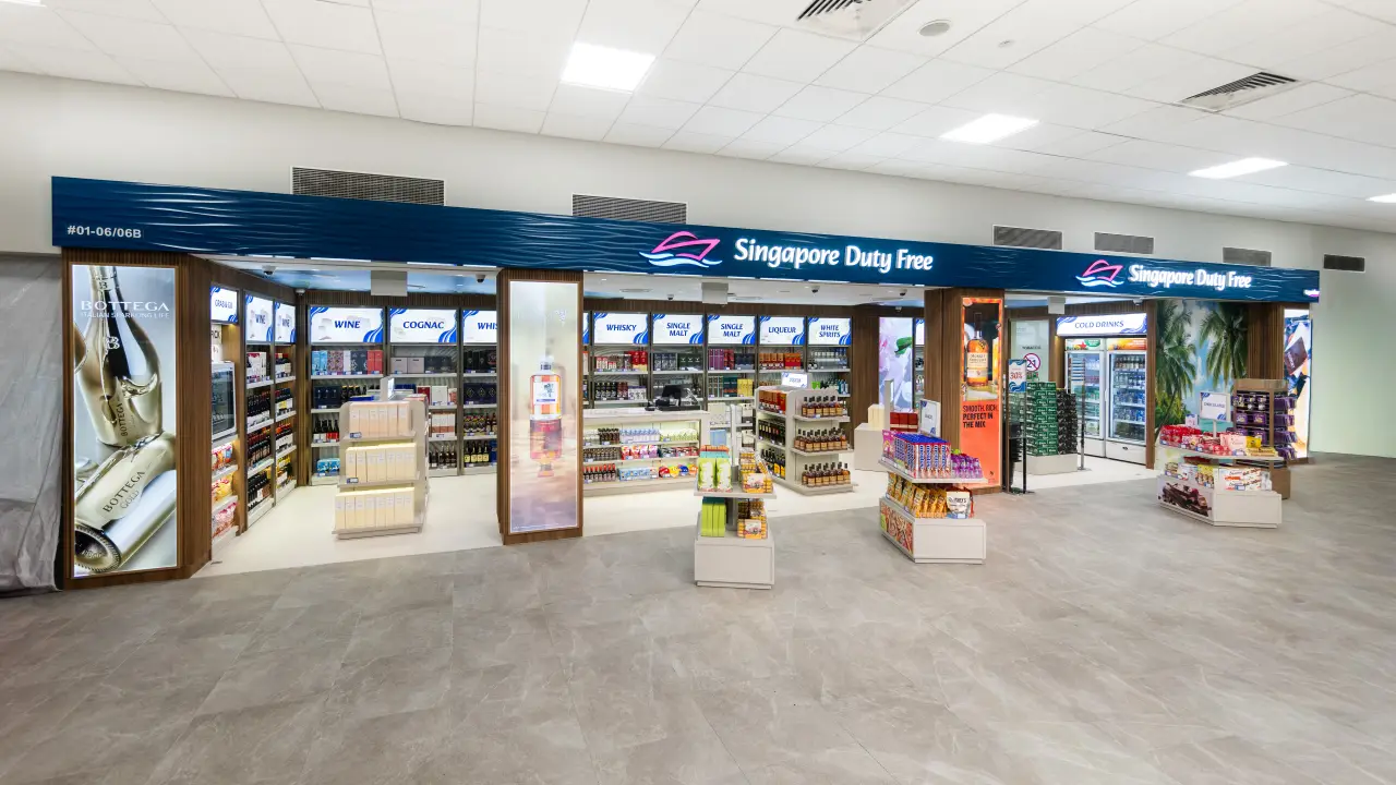 Interior view of Singapore Duty Free store at Tanah Merah Ferry Terminal with liquor, wine, and confectionery displays.