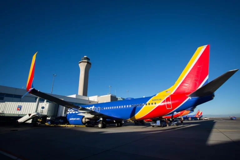 Southwest Airlines aircraft parked at airport gate under clear sky