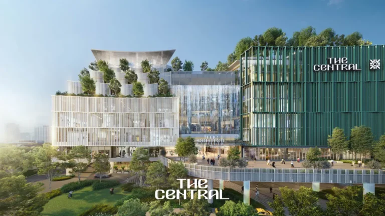 Exterior rendering of The Central, a modern retail development in Bangkok with greenery and a large glass façade.