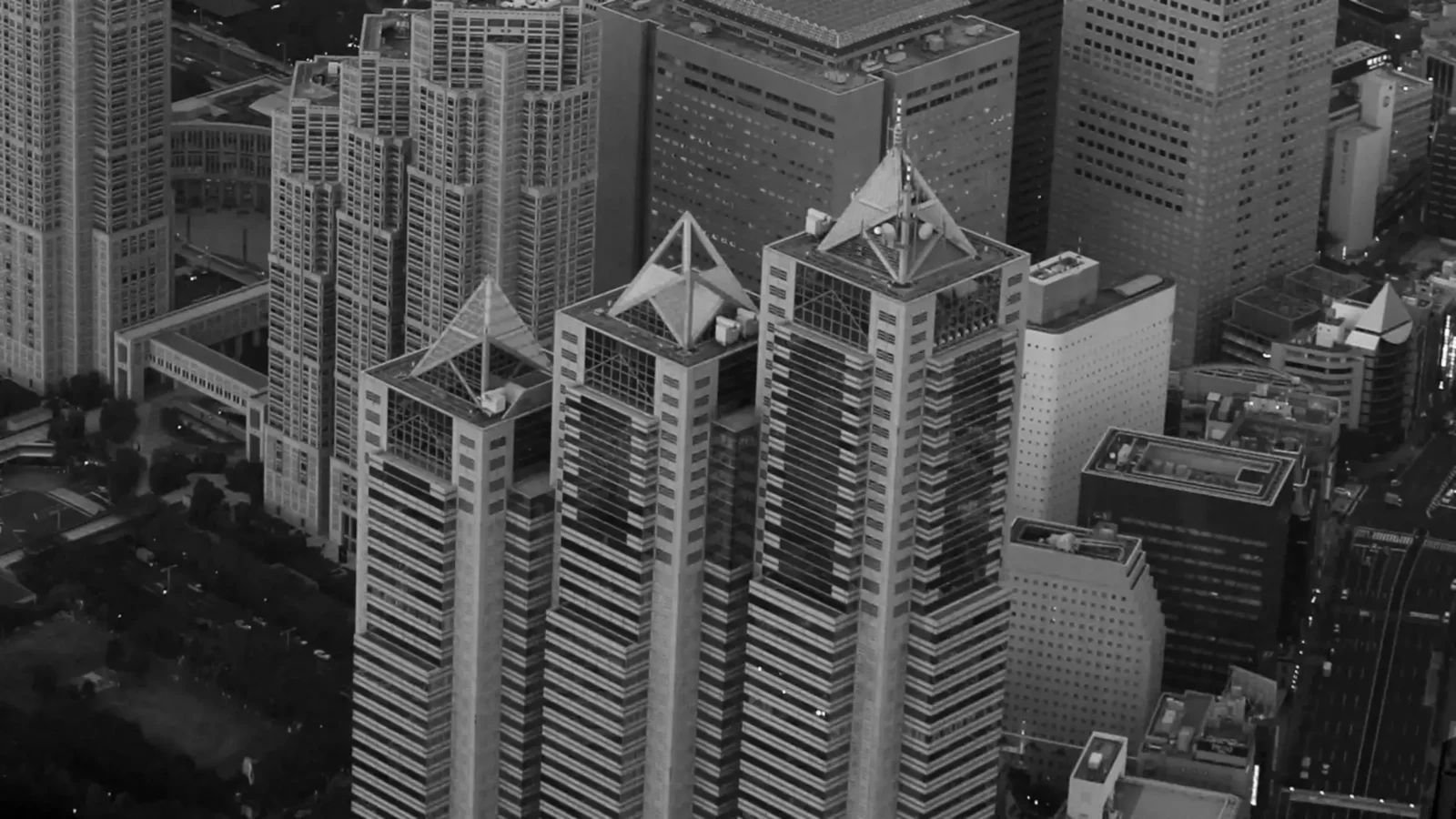 Aerial view of Shinjuku Park Tower in Tokyo, home to Park Hyatt Tokyo, surrounded by high-rise buildings.