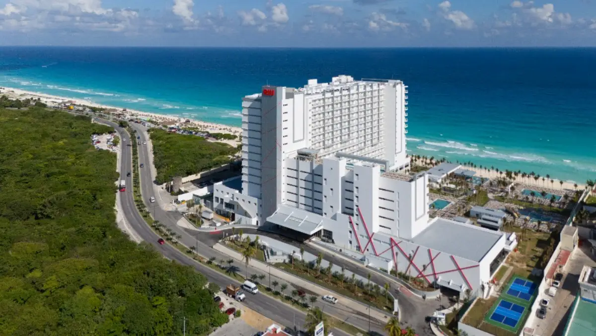 Aerial view of the Riu Ventura hotel in Cancun overlooking the Caribbean Sea and beachfront.