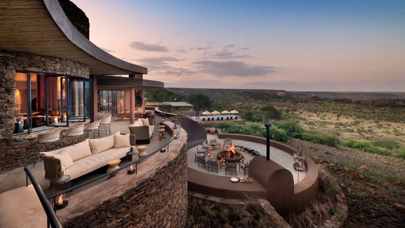 Luxury lodge terrace at &Beyond Suyian Lodge overlooking the Laikipia landscape in Kenya at sunset