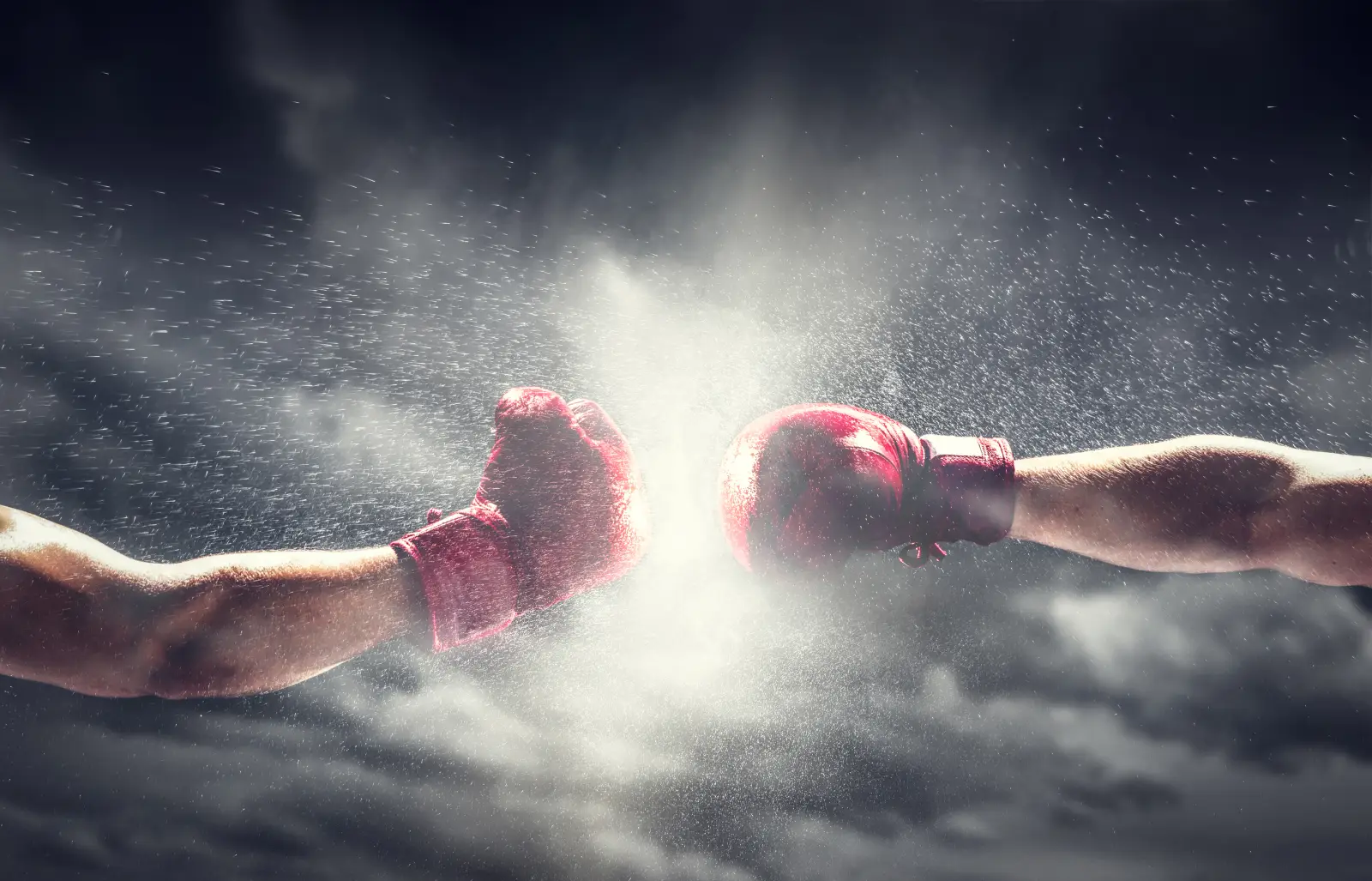 Two boxing gloves colliding mid-air with dramatic burst of dust and light