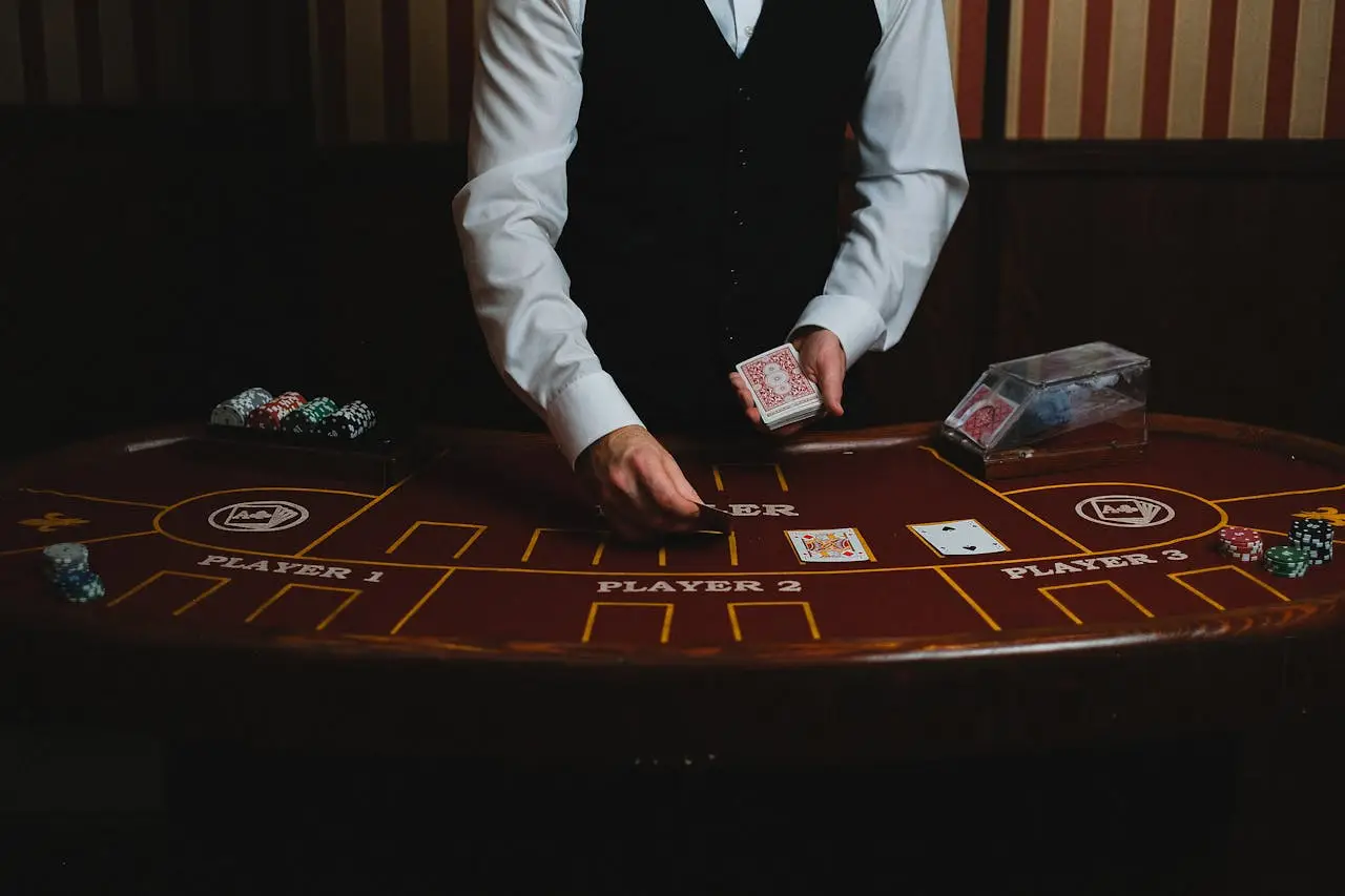 Casino dealer dealing cards at a poker table during a live game
