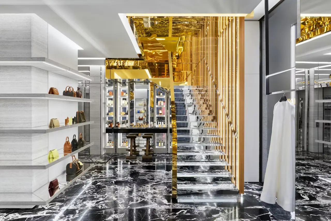 Interior of Celine’s Milan store featuring marble floors and gold staircase