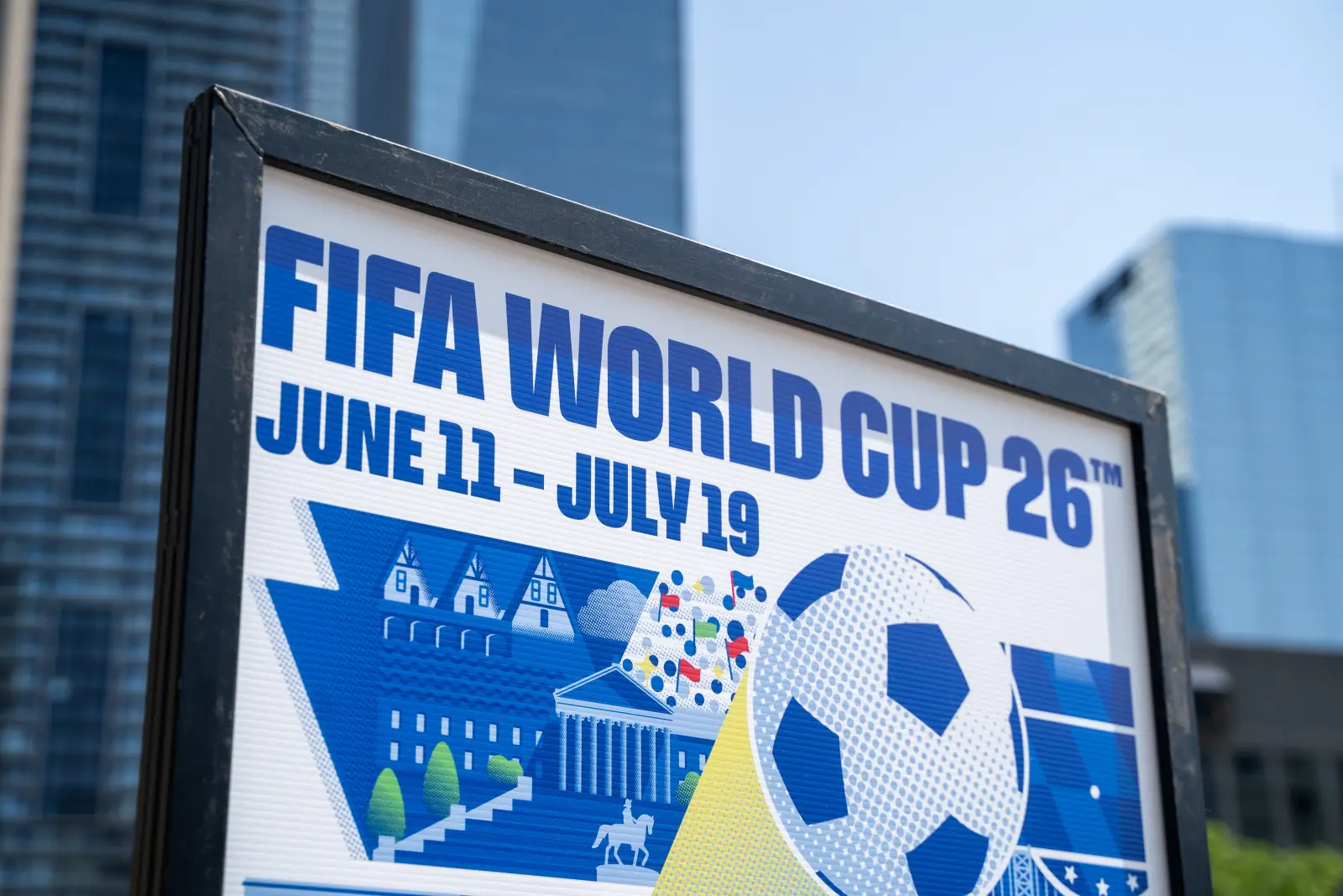 Sign advertising the FIFA World Cup 2026 with dates displayed in an urban city setting.