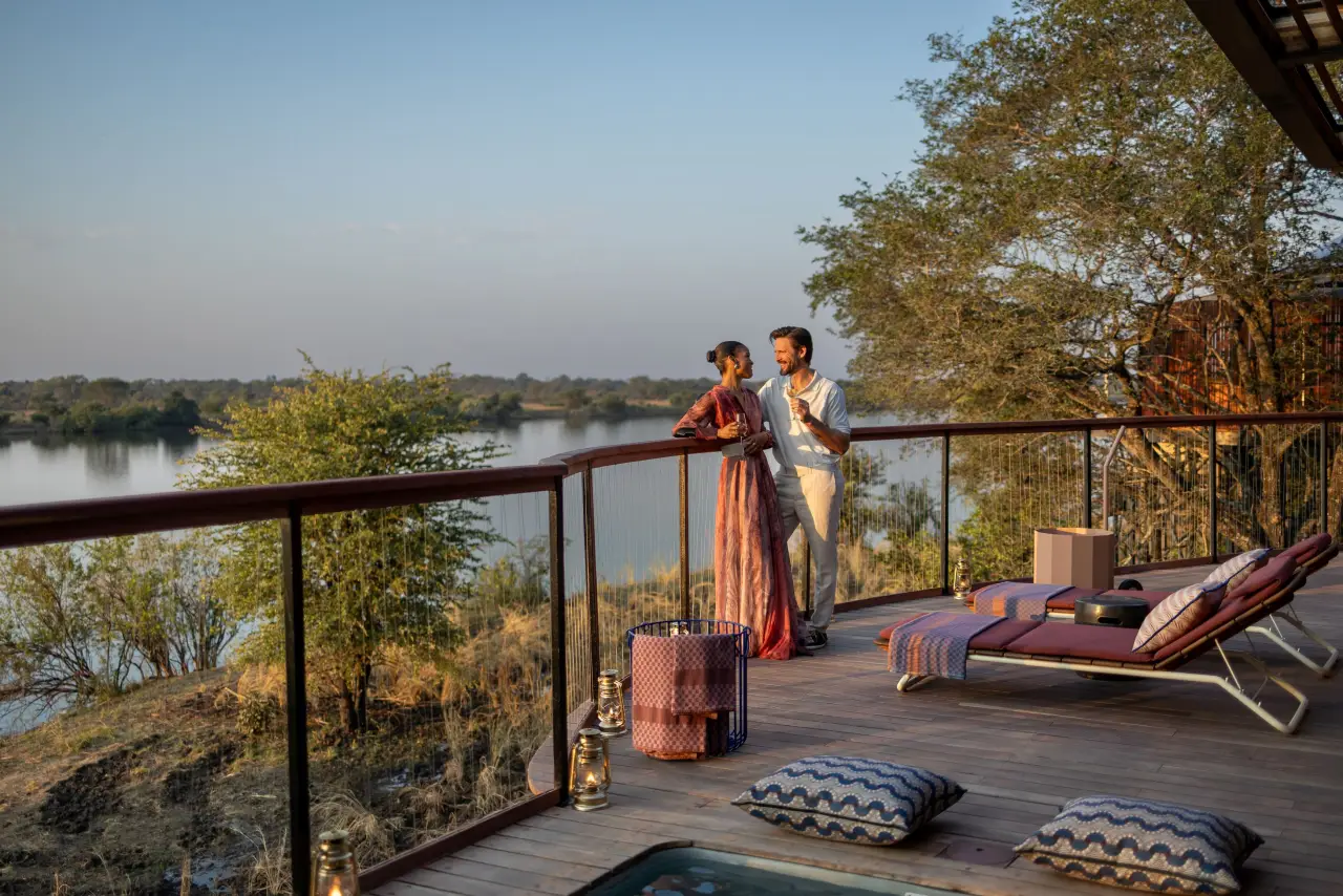 Minor Hotels To Open New Hotels In The Middle East And Africa In 2026 Including Debut Of New Brands And Concepts 3 Couple enjoying sunset drinks on a private deck overlooking the Kafue River at Anantara Kafue River Zambia Tented Camp.