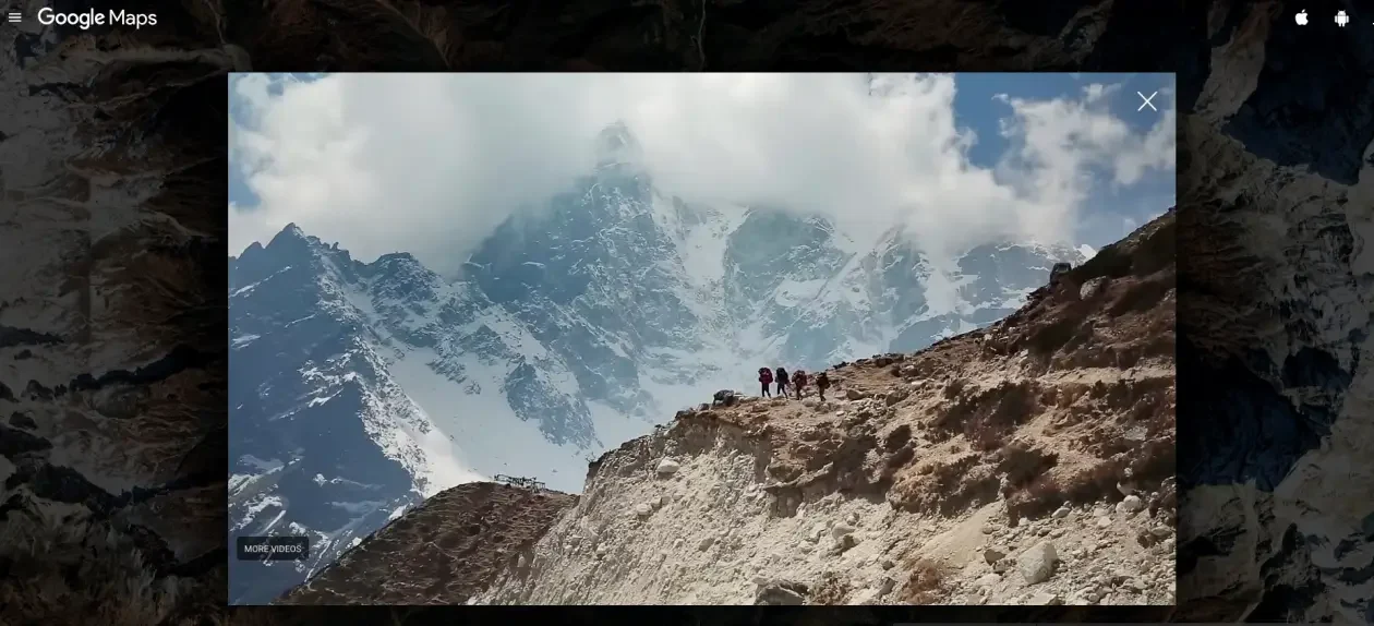 Trekkers walking along a rocky trail in Nepal’s Khumbu region with snow-covered Himalayan peaks in the background.