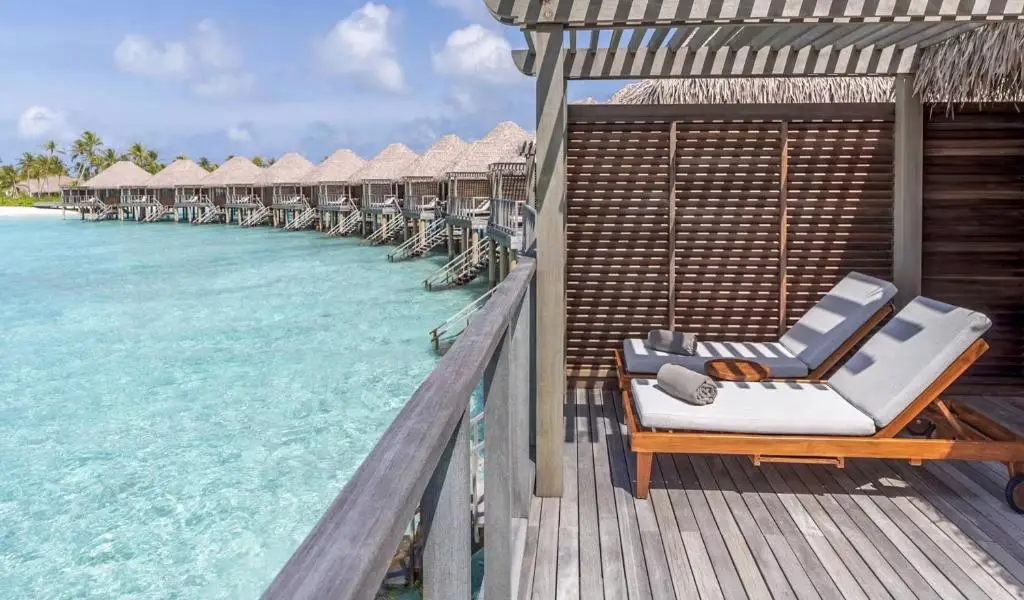 New Maldives Hotels &Amp; Resorts, 2025 &Amp; 2026 3 Overwater villas with a private deck and sun loungers overlooking a turquoise lagoon at a Maldives luxury resort.