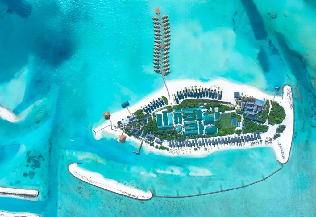 New Maldives Hotels &Amp; Resorts, 2025 &Amp; 2026 6 Aerial view of Nala Maldives by Jawakara with overwater villas, beachfront buildings, and turquoise lagoon surrounding a private island.
