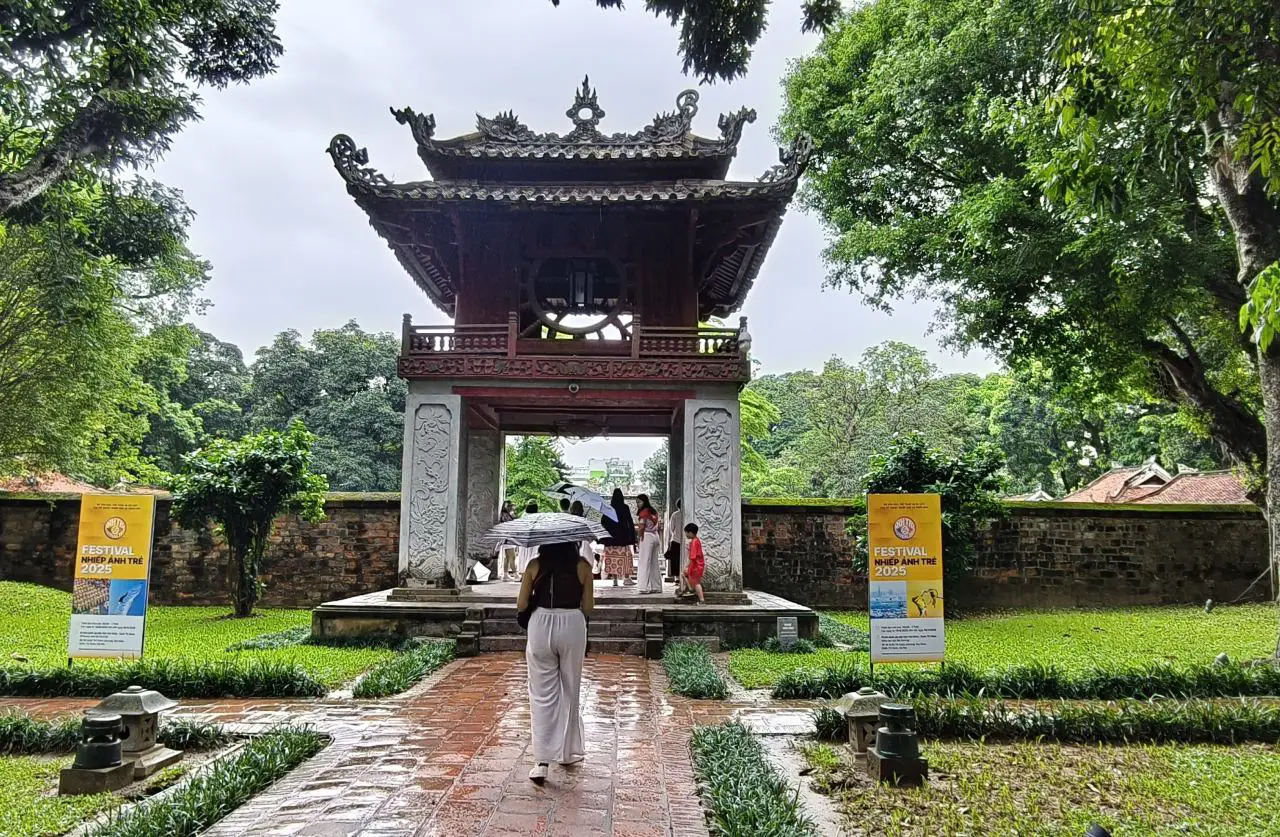 Temple Of Literature In Hanoi Showcases Vietnam’s Ode To Academic Excellence 5 The Constellation of Literature Pavilion at the Temple of Literature in Hanoi, a two-storey wooden structure with ornate roof details, surrounded by trees and gardens.