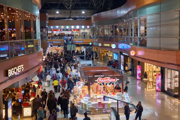News From Turkey - Türkiye 22 Busy duty-free shopping area inside Istanbul Sabiha Gökçen Airport with travelers browsing stores