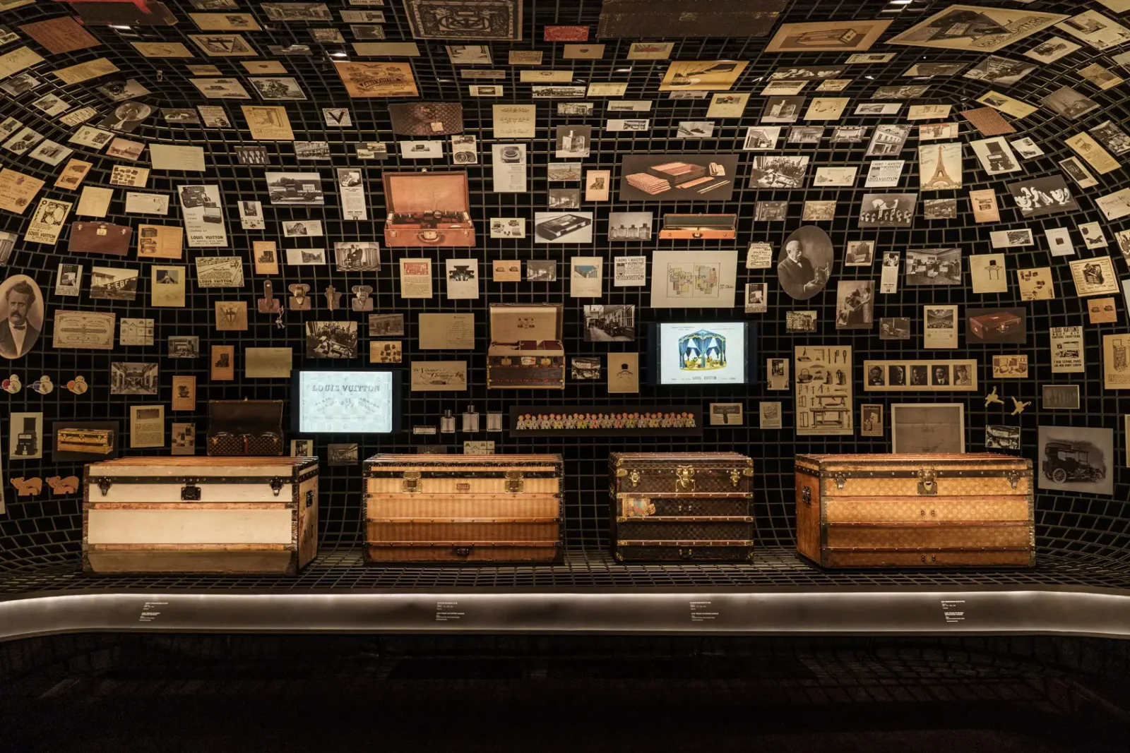 Display of vintage Louis Vuitton trunks and archival photos inside the “Visionary Journeys” exhibition at The Louis installation in Shanghai.