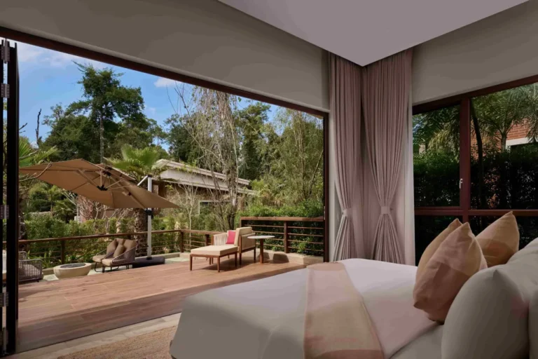 Luxury Travel 40 Luxury villa bedroom at Samanea Wellness Resort opening onto a private terrace surrounded by tropical forest in Cambodia