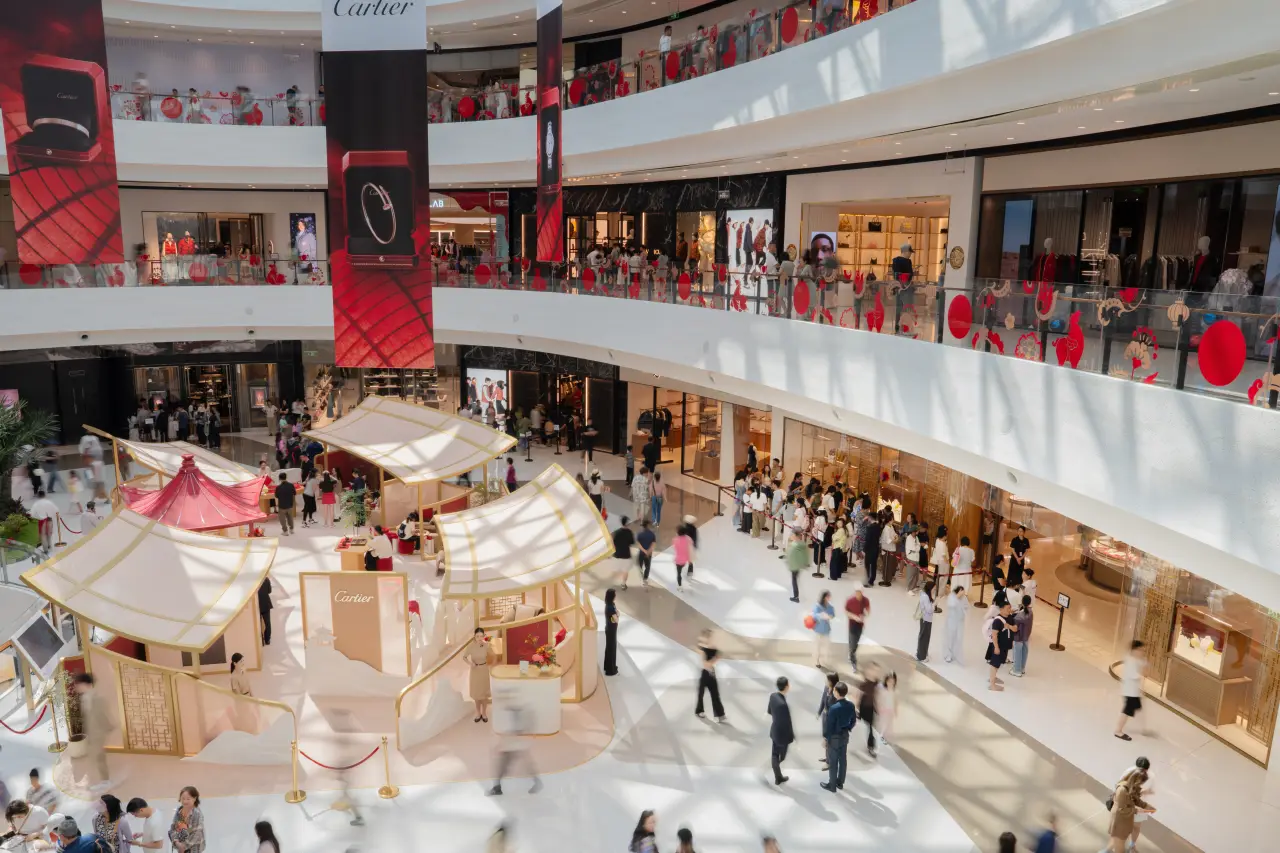 Cartier Chinese New Year pop-up at CDF Sanya duty-free complex with festive red decor and shoppers