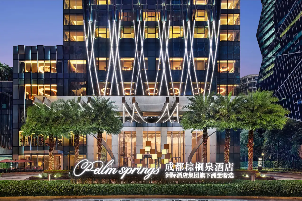 Ihg’s Vignette Collection Reaches 10 Open Hotels In Greater China 3 Modern hotel entrance at night with illuminated facade, palm trees, and Palm Springs signage in Chengdu