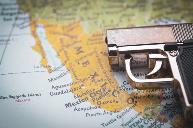 Other News 21 Handgun placed over a map of Mexico highlighting Guadalajara and central regions, symbolizing cartel violence and travel safety concerns.