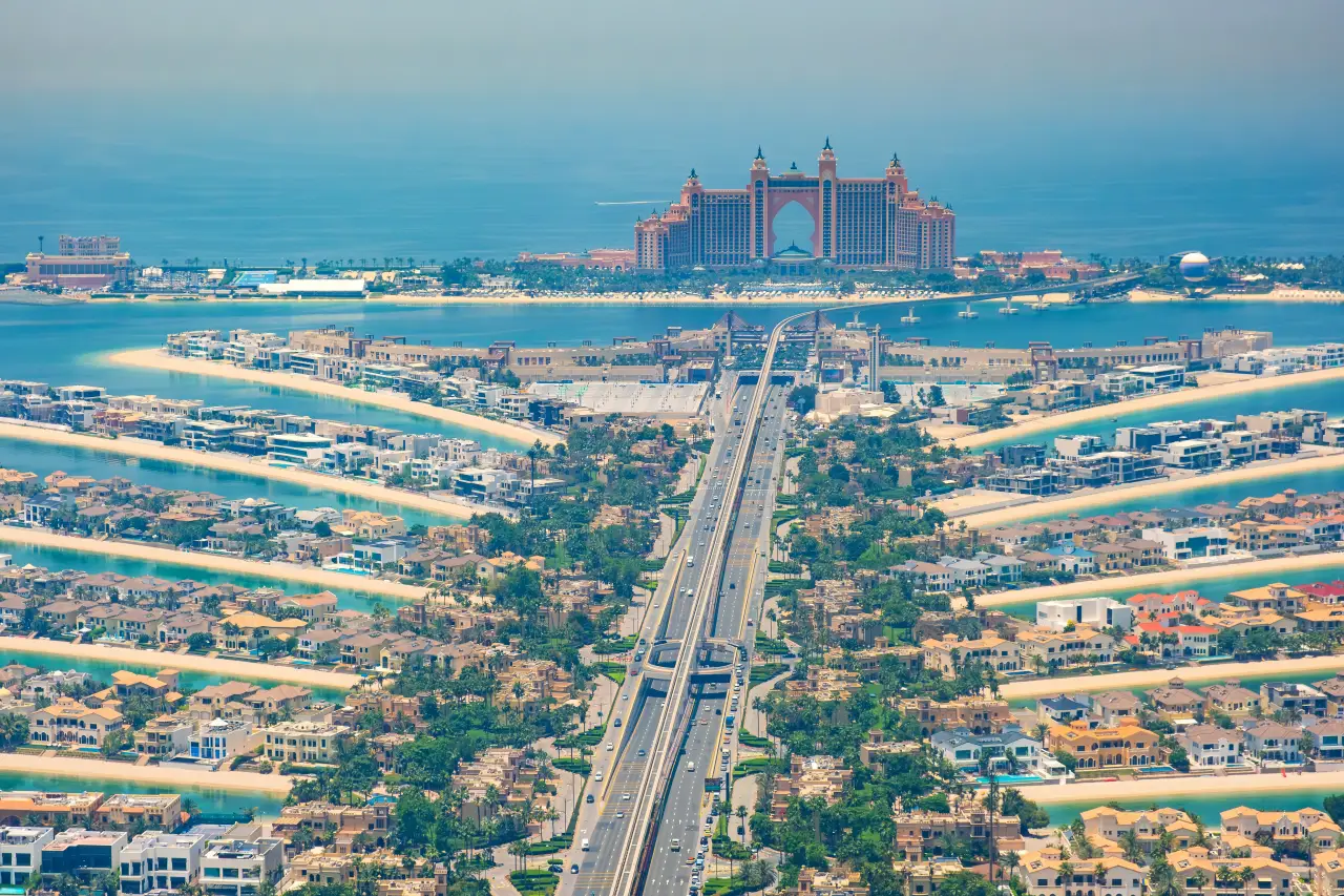 Aerial view of Palm Jumeirah in Dubai with Atlantis The Palm hotel and connecting bridge over turquoise waters