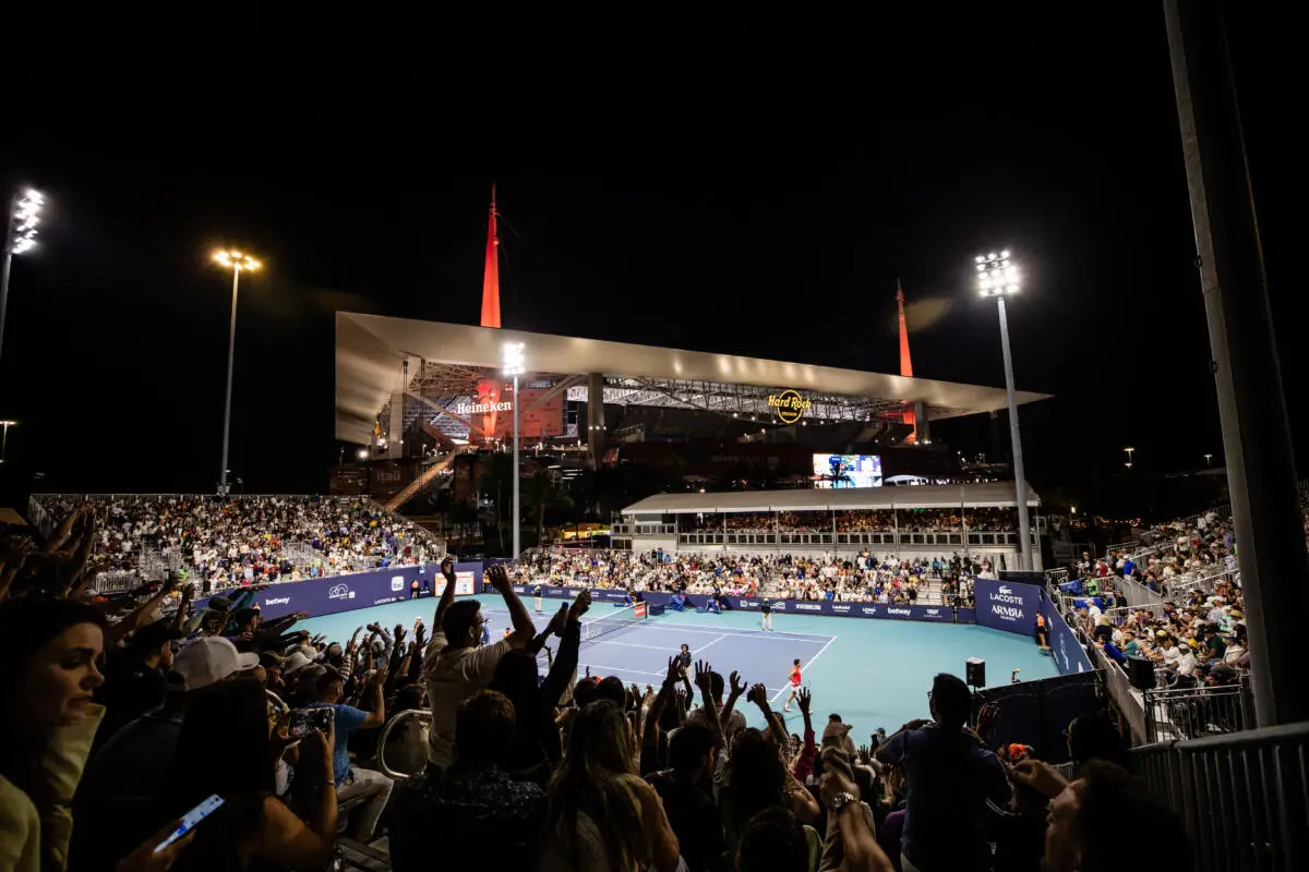 Crowds watch a night tennis match at Hard Rock Stadium during the Miami Open tennis tournament in Miami Gardens, Florida.