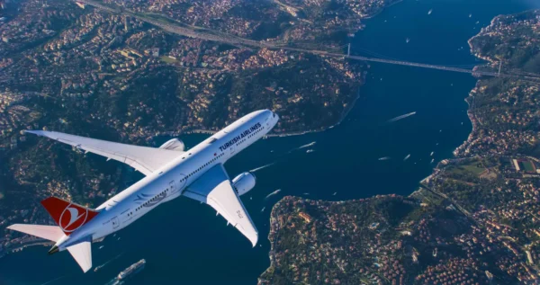 Turkish Airlines passenger jet flying over the Bosphorus and Istanbul cityscape