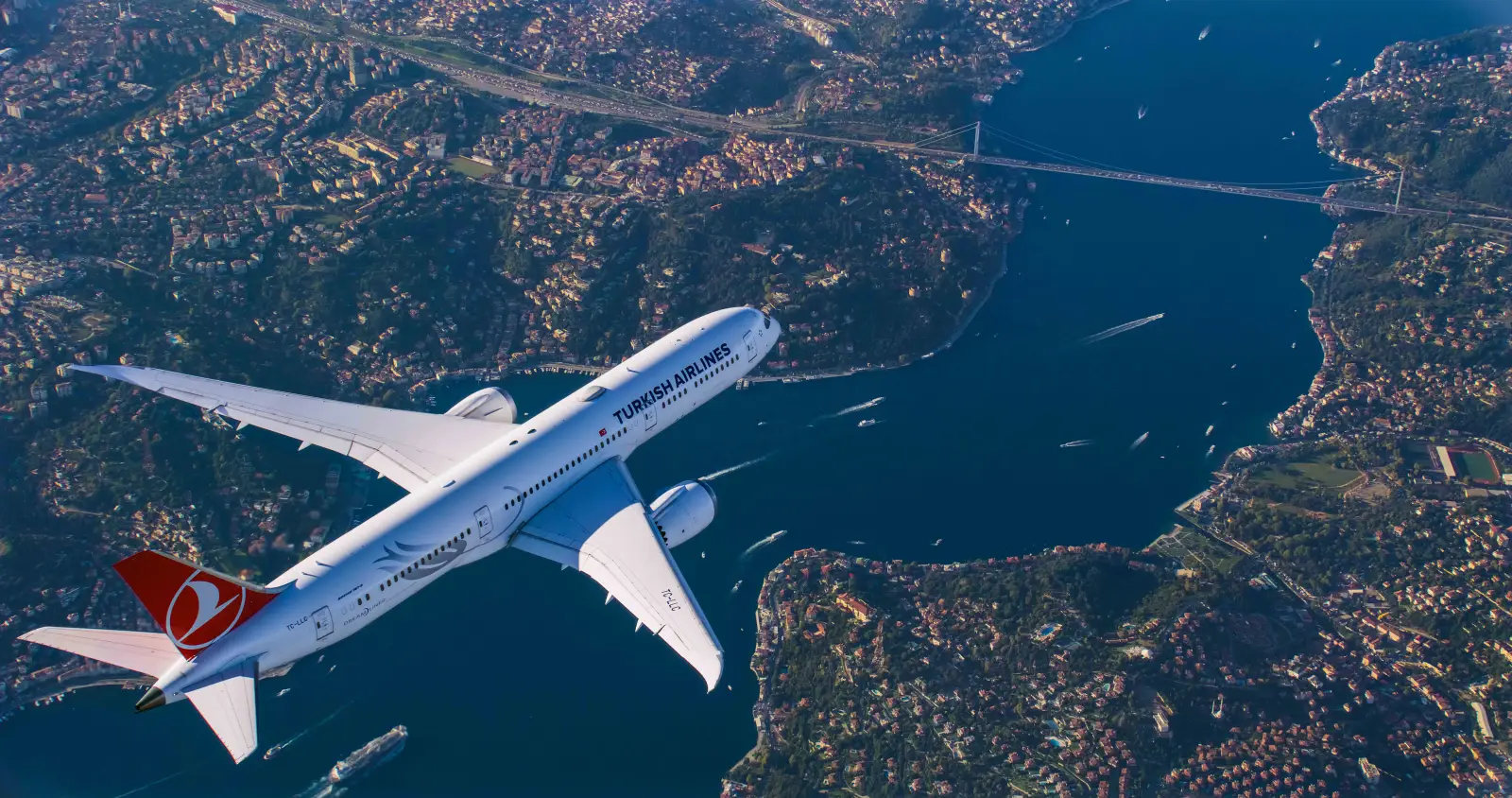 Turkish Airlines passenger jet flying over the Bosphorus and Istanbul cityscape