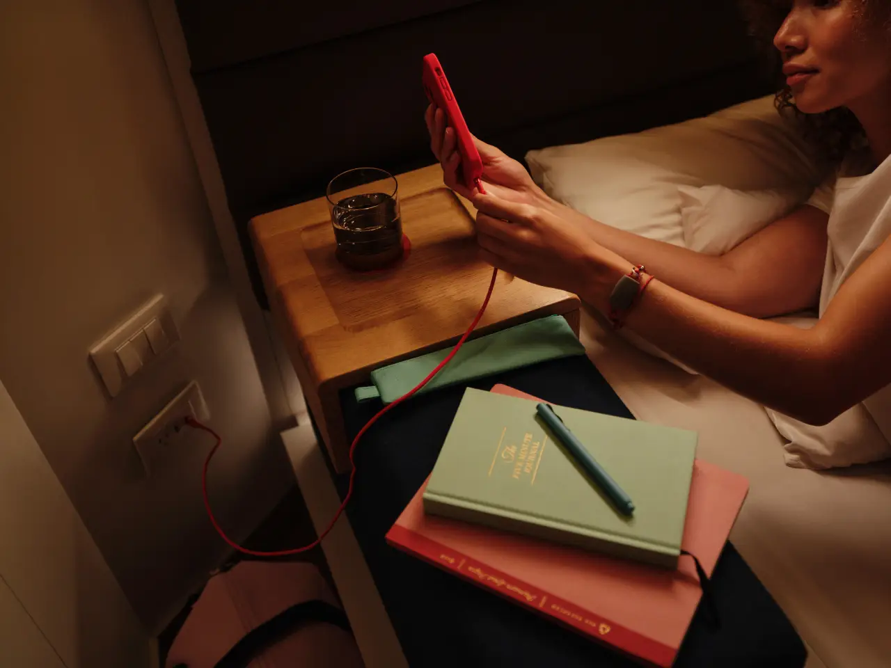 Virgin Voyages Surpasses 1,500 Ai Agents In Less Than Four Months 3 Person using phone beside notebooks.