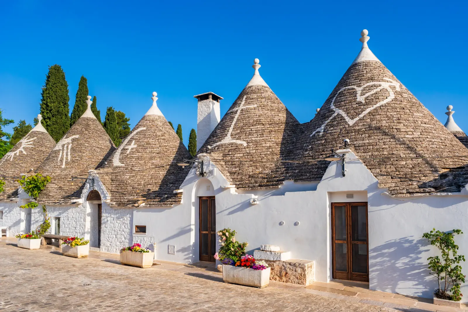 Traditional trulli houses with cone-shaped stone roofs in Alberobello, Puglia, Italy