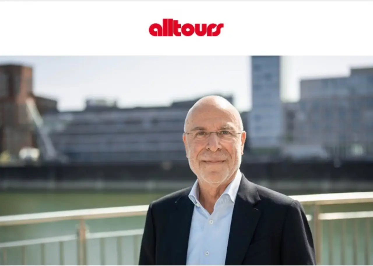 Willi Verhuven, Founder and Owner of Alltours, standing outdoors with company logo above