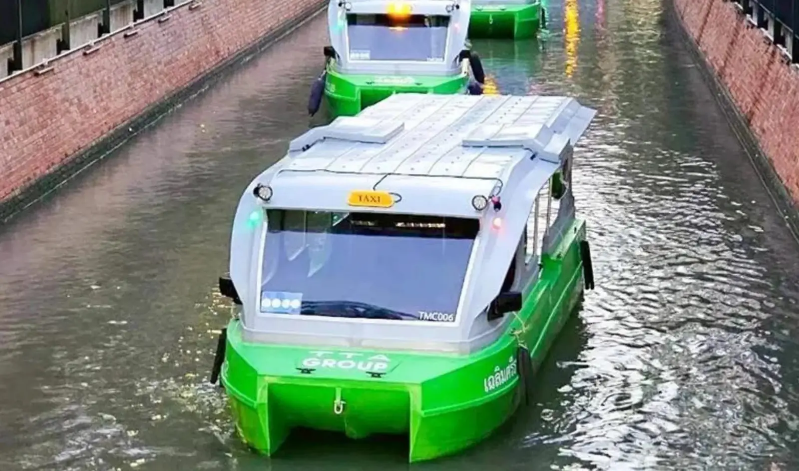 Electric taxi boat operating on a narrow Bangkok canal, showcasing eco-friendly urban transport with modern vessel design